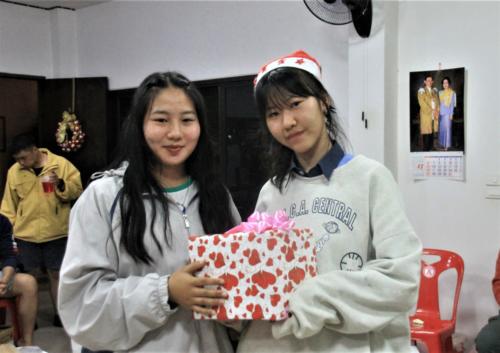 Mind receives a gift from her Christmas buddy, Muei!