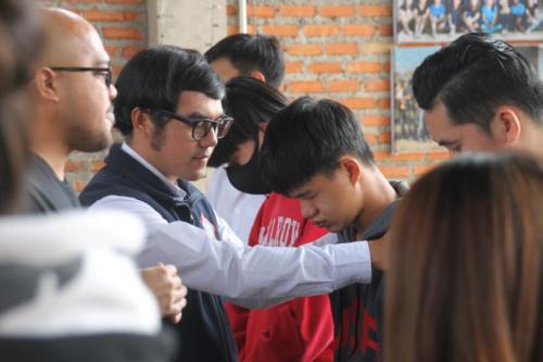 Mark and Asanee praying with boys.