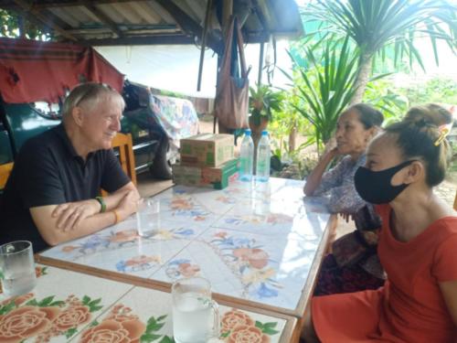 Bill, Nong’s mom, and Nong discussing prayer needs.